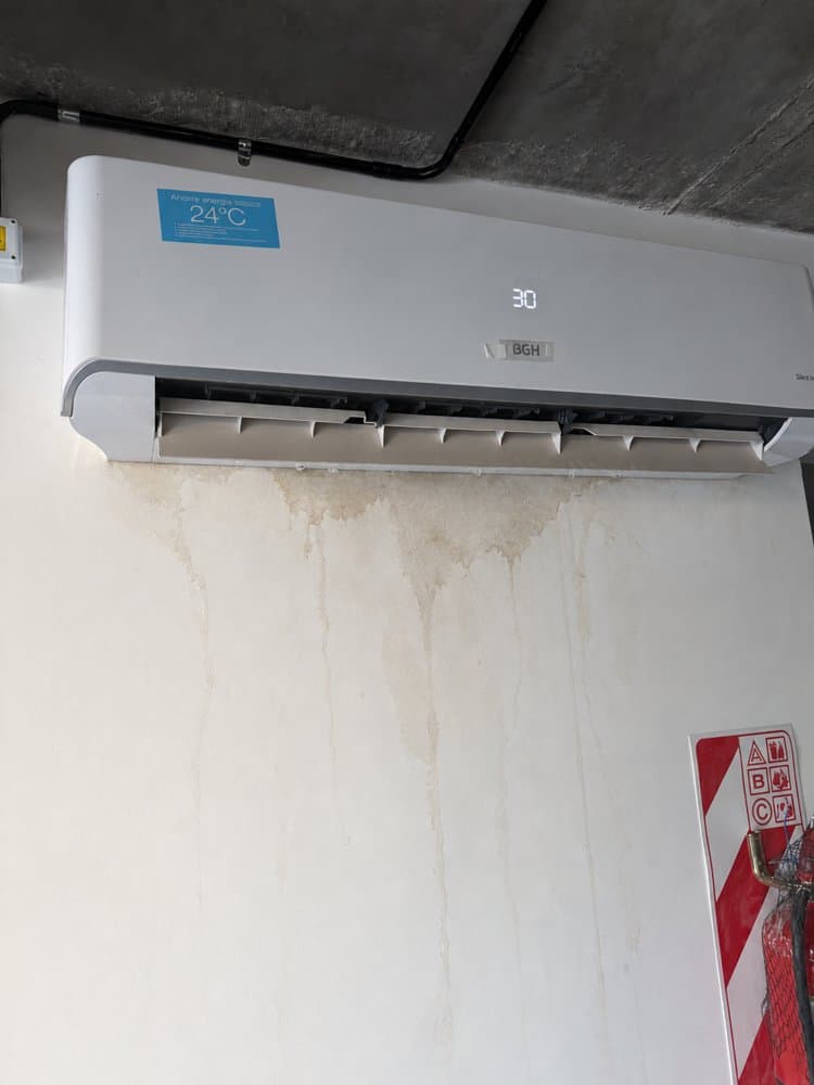 The same air conditioner with water stains added to the wall by an AI editing tool