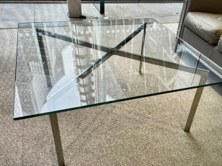 Capture under review: a glass coffee table with a chrome frame, photographed in a showroom